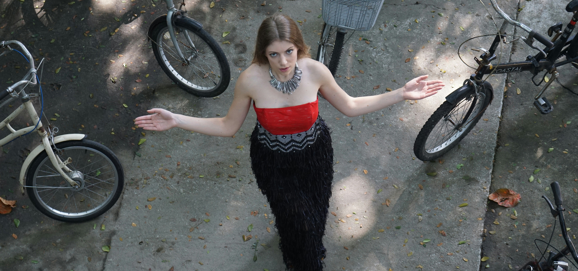 Fashion model photographed from above wearing a red and black textured evening look