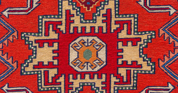 Detail of a woven textile showing a traditional geometric pattern and yarn structure